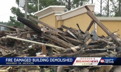 Burned building being torn down on Highway 18