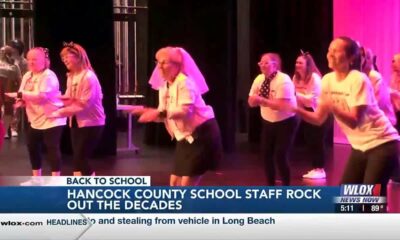 Hancock County Schools staff rocks out the decades with back-to-school rally