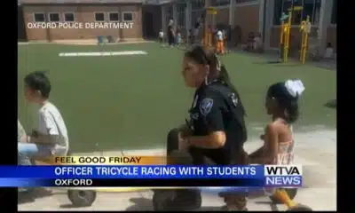 Oxford Police officer rides tricycle with kids