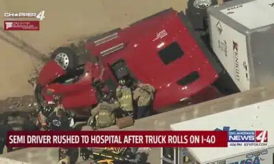 Semi driver rushed to hospital after truck rolls on I-40