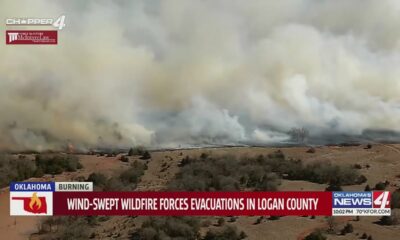 Wind-swept wildfire forces evacuations in Logan County