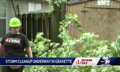 People in Gravette cleaning up after storm Tuesday morning.L