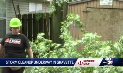 People in Gravette cleaning up after storm Tuesday morning.L