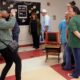 Former students gather for a photo at Coston Elementary during an open house ahead of the school's closure.
