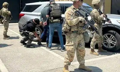 National Guard soldiers deployed this month to Los Angeles guard ICE agents during an immigration enforcement operation.