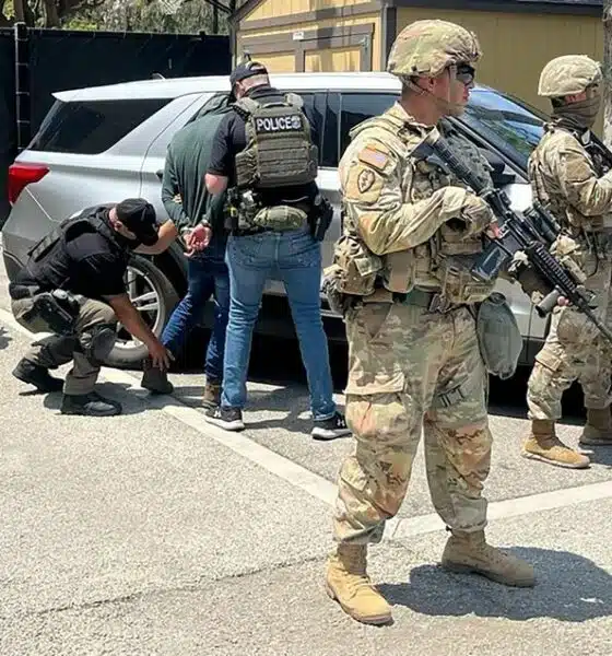 National Guard soldiers deployed this month to Los Angeles guard ICE agents during an immigration enforcement operation.