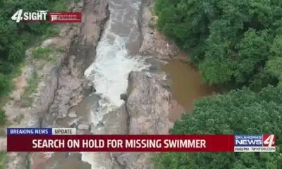 Search on hold for missing swimmer