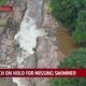 Search on hold for missing swimmer