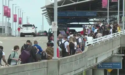 Lines extend outside Lambert Airport terminal as large St. Louis convention group leaves