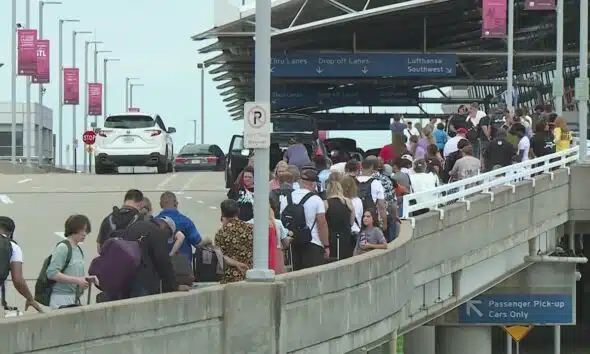 Lines extend outside Lambert Airport terminal as large St. Louis convention group leaves