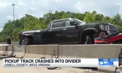 Pickup truck crashes into divider