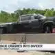 Pickup truck crashes into divider