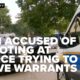 Man accused of shooting at police who were trying to serve warrants in murder investigation