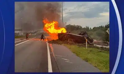 Witness rushes to help driver after a tractor-trailer overturns and bursts into flames