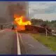 Witness rushes to help driver after a tractor-trailer overturns and bursts into flames
